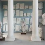 Classical statues and sculptures in museum gallery.