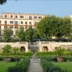 Historic garden in Rome with grand staircase and trees.